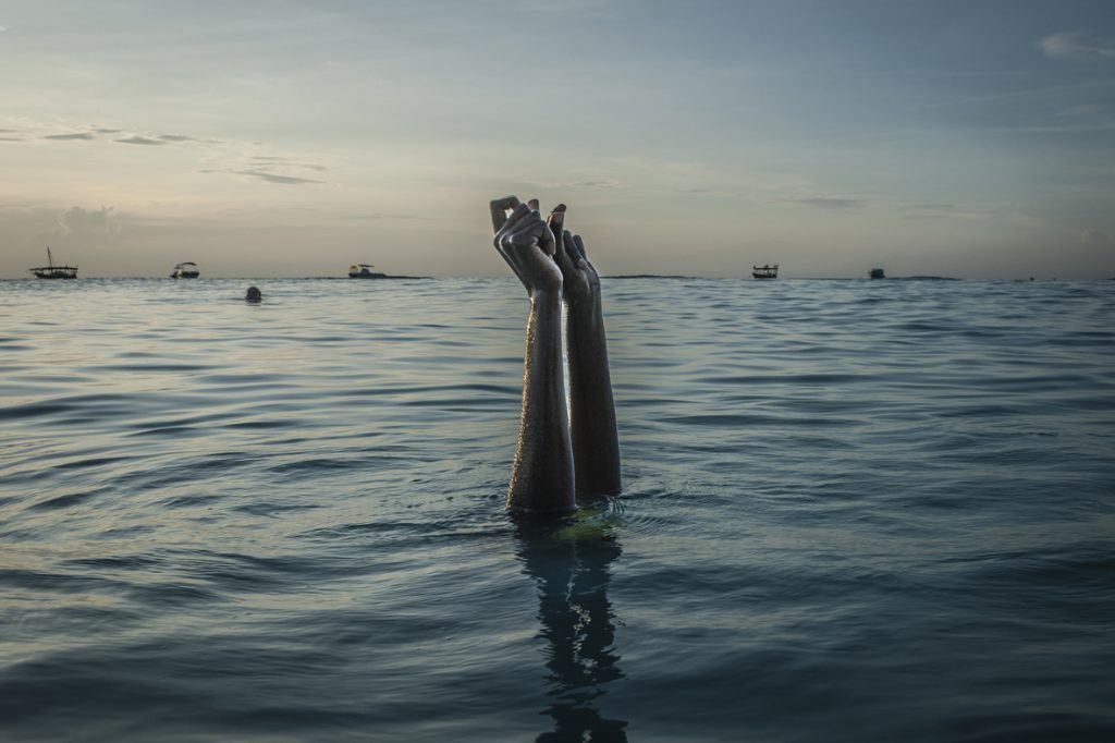 Swim instructor Chema, 17, snaps her fingers as she disappears underwater on Wednesday, December 28, 2016 in Nungwi, Zanzibar. — Daily life in the Zanzibar Archipelago centers around the sea, yet the majority of girls who inhabit the islands never acquire even the most fundamental swimming skills. Conservative Islamic culture and the absence of modest swimwear have compelled community leaders to discourage girls from swimming. Until now. For the past few years, the Panje Project has made it possible for local women and girls to get into the water, not only teaching them swimming skills but aquatic safety and drowning prevention techniques. The group has empowered its students to teach others, creating a sustainable cycle. Students are also provided full-length swimsuits, so that they can enter the water without compromising their cultural and religious beliefs. While the wearing of full-length swimsuits may be seen as subjugation, donning one in order to learn a vital life skill, which has long been and would otherwise be forbidden, is an important first step toward emancipation. Education — whether it be in or out of the water — serves as a springboard providing women and girls the empowerment and tools with which to claim their rights and challenge existing barriers. The rate of drowning on the African continent is the highest in the world. Still, many community leaders have yet to warm up to the idea of women and girls learning to swim. The swimming lessons challenge a patriarchal system that discourages women from pursuing things other than domestic tasks. It is this tension of the freedom one feels in and under water juxtaposed with the limitations imposed upon Zanzibari women that is at the heart of this series.