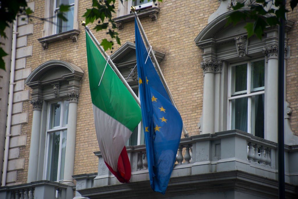 Italian and European flags wave outside the Embassy of the Italian Republic in London, on May 29, 2018. Italian President Sergio Mattarella has asked an ex-IMF economist to form a government as the country faces fresh political turmoil. Two of the big winners from the vote, Five Star and the League, attempted to join forces but abandoned efforts after the president vetoed their choice of finance minister. Mr Mattarella said he could not appoint the Eurosceptic Paolo Savona to the post, citing concern from investors at home and abroad. The rare move by the president sparked fury from both parties, who say they will reject Mr Cottarelli's nomination in parliament.  (Photo by Alberto Pezzali/NurPhoto via Getty Images)